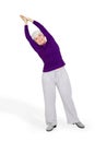 Happy charming beautiful elderly woman doing exercises while working out playing sports Royalty Free Stock Photo