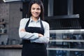 Happy charming female waiter in apron