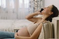 Happy charming pregnant woman using mobile phone. Pregnant Woman