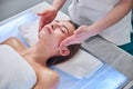 Happy cheerful adorable woman relaxing at the massage therapy in spa resort center Royalty Free Stock Photo