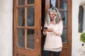 Happy and cheerful adult alternative woman using technology outside home in the garden - long grey hair and smille using a mobile
