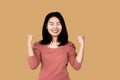 Happy cheerful Asian business woman smiling over grey wall background Royalty Free Stock Photo
