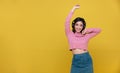 Happy cheerful Beautiful Asian woman wearing wireless headphones enjoying listening to music on yellow background.People lifestyle Royalty Free Stock Photo