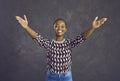 Happy African American woman spreads her arms wide open to welcome and hug someone Royalty Free Stock Photo