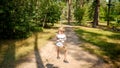 Happy cheerful boy riding down the zip-line rope at outdoor adventure park. Active childhood, healthy lifestyle, kids playing Royalty Free Stock Photo