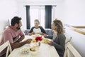 Happy and cheerful caucasian family having lunch together at home. white wall and bright image. together enjoy the day smiling and