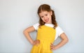 Happy cheerful child girl in yellow dress