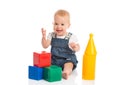 Happy cheerful child playing with blocks cubes on white