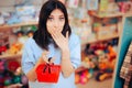 Funny Customer Holding a Small Shopping Basket and Laughing