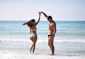 Happy cheerful couple having fun dancing running in the sea together. Romantic vacation, honeymoon love Royalty Free Stock Photo