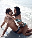 Happy cheerful couple kissing hugging in the sea together. Romantic vacation, honeymoon love Royalty Free Stock Photo