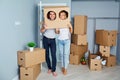 Happy cheerful couple in a new apartment for a housewarming part Royalty Free Stock Photo