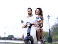 Happy cheerful couple riding vintage scooter. Travel concept. Royalty Free Stock Photo