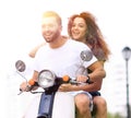 Happy cheerful couple riding vintage scooter. Travel concept. Royalty Free Stock Photo