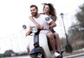 Happy cheerful couple riding vintage scooter. Travel concept. Royalty Free Stock Photo