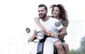 Happy cheerful couple riding vintage scooter. Travel concept. Royalty Free Stock Photo