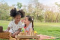 Happy cheerful ethnic girls play wooden block puzzle together at outdoors park , Relationship little kids, Diverse ethnic concept Royalty Free Stock Photo