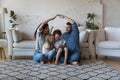 Happy cheerful family couple playing house, sitting on heating floor Royalty Free Stock Photo