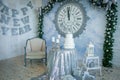 Christmas home interior decorated in gray, blue colors. Table shiny tablecloth, festive cake, silver gifts. Royalty Free Stock Photo