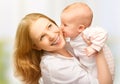 Happy cheerful family. Mother and baby kissing