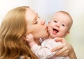 Happy cheerful family. Mother and baby kissing Royalty Free Stock Photo