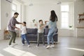 Happy parents and children dancing and having fun in their new house or apartment Royalty Free Stock Photo