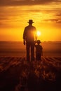 happy cheerful father with child walking by cereal field at sunset, man with daughter or son playing at summer Royalty Free Stock Photo