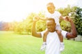 Happy and cheerful father and son doing piggyback in park Royalty Free Stock Photo