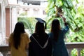 Happy and cheerful Female university graduate students in academic dress chat with friends who came to congratulate on Royalty Free Stock Photo