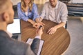 Happy cheerful girl getting a car key with handsome man in showroom. Business concept and car selling Royalty Free Stock Photo