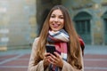 Happy cheerful girl messaging with smart phone app looking at ca Royalty Free Stock Photo