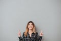 Happy cheerful girl pointing two fingers up at copy space Royalty Free Stock Photo