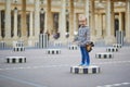 Happy cheerful girl running in Palais Royale in Paris Royalty Free Stock Photo