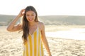 Happy cheerful girl in summer dress walking on sand beach. Portrait of happy young woman smiling at sea on Costa Papagayo beach, Royalty Free Stock Photo