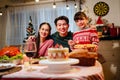 Happy and Cheerful group of extended Asian family and daughter smiling during Christmas dinner at home. Celebration holiday