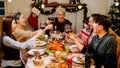 Happy and Cheerful group of extended Asian family has a toast and cheer during Christmas dinner at home. Celebration holiday Royalty Free Stock Photo