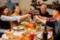 Happy and Cheerful group of extended Asian family has a toast and cheer during Christmas dinner at home. Celebration holiday Royalty Free Stock Photo