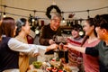 Happy and Cheerful group of extended Asian family has a toast and cheer during Christmas dinner at home. Celebration holiday Royalty Free Stock Photo