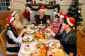 Happy and Cheerful group of extended Asian family has a toast and cheer during Christmas dinner at home. Celebration holiday Royalty Free Stock Photo