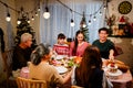 Happy and Cheerful group of extended Asian family talking and smiling during Christmas dinner at home. Celebration holiday