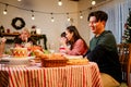 Happy and Cheerful group of extended Asian family talking and smiling during Christmas dinner at home. Celebration holiday