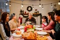 Happy and Cheerful group of extended Asian family talking and smiling during Christmas dinner at home. Celebration holiday