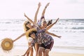 Happy cheerful group of young people friends having fun together in friendship at the beach with sea in background - tourism Royalty Free Stock Photo