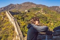 Happy cheerful joyful tourist man at Great Wall of China having fun on travel smiling laughing and dancing during Royalty Free Stock Photo