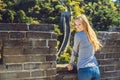 Happy cheerful joyful tourist woman at Great Wall of China having fun on travel smiling laughing and dancing during Royalty Free Stock Photo