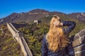 Happy cheerful joyful tourist woman at Great Wall of China having fun on travel smiling laughing and dancing during Royalty Free Stock Photo