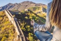 Happy cheerful joyful tourist woman at Great Wall of China meditates on vacation trip in Asia. Girl visiting and Royalty Free Stock Photo