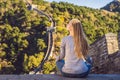 Happy cheerful joyful tourist woman at Great Wall of China meditates on vacation trip in Asia. Girl visiting and Royalty Free Stock Photo