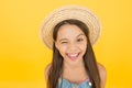 Happy cheerful kid in summer hat yellow background. Funny grimace. Stunning girl in hat. Cheerful face. Emotional child Royalty Free Stock Photo