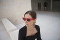 Happy and cheerful mature woman outdoor, wearing retro red sunglasses. Royalty Free Stock Photo